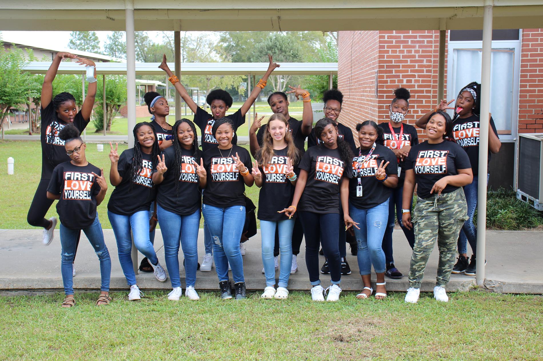Girls in matching black Unity Day shirts pose for a Silly Group Photo
