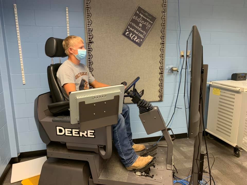 A student works on the John Deere backhoe simulator.