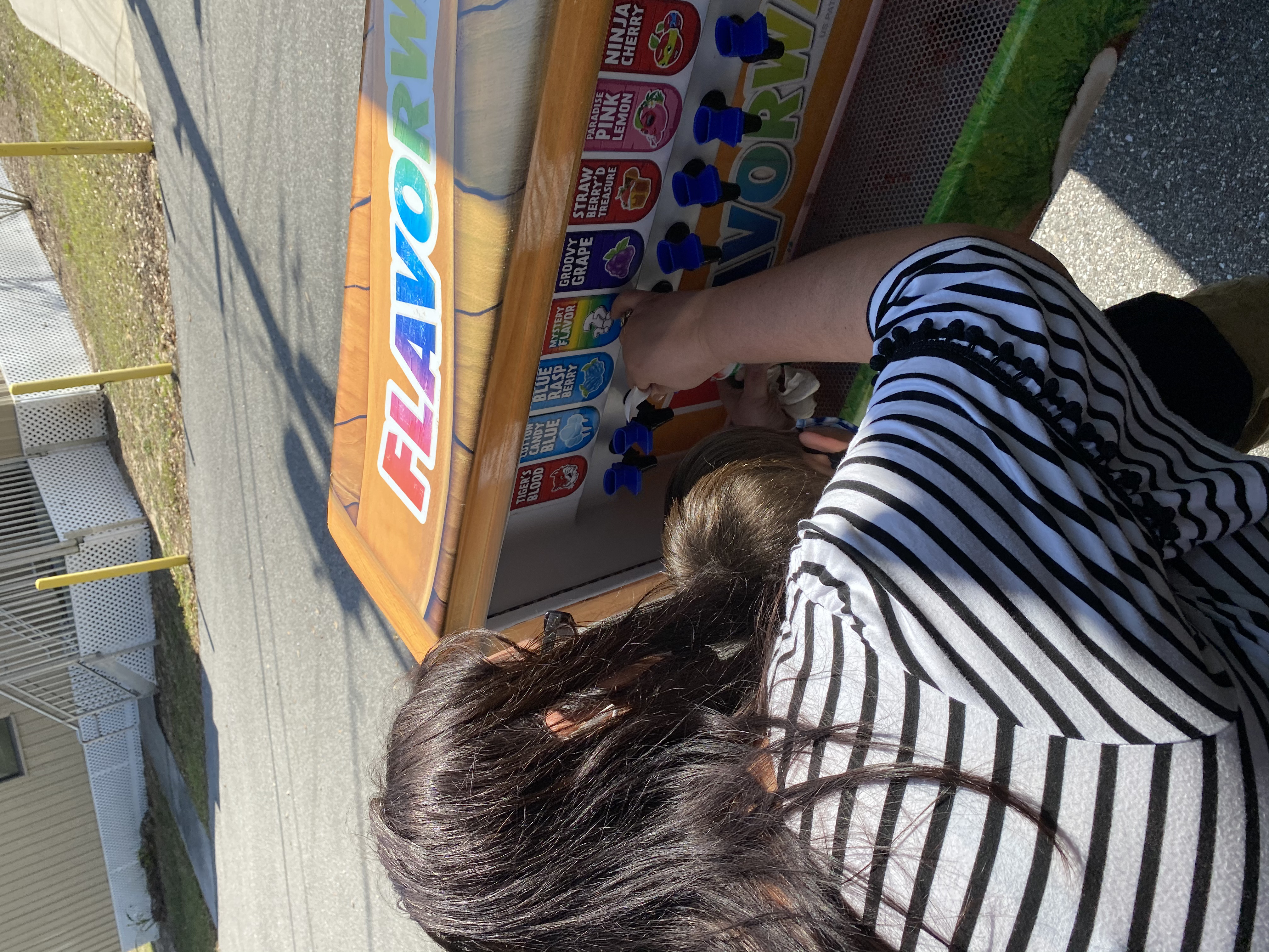 Mrs. Jacobs helping a student add flavoring to their Kona Ice