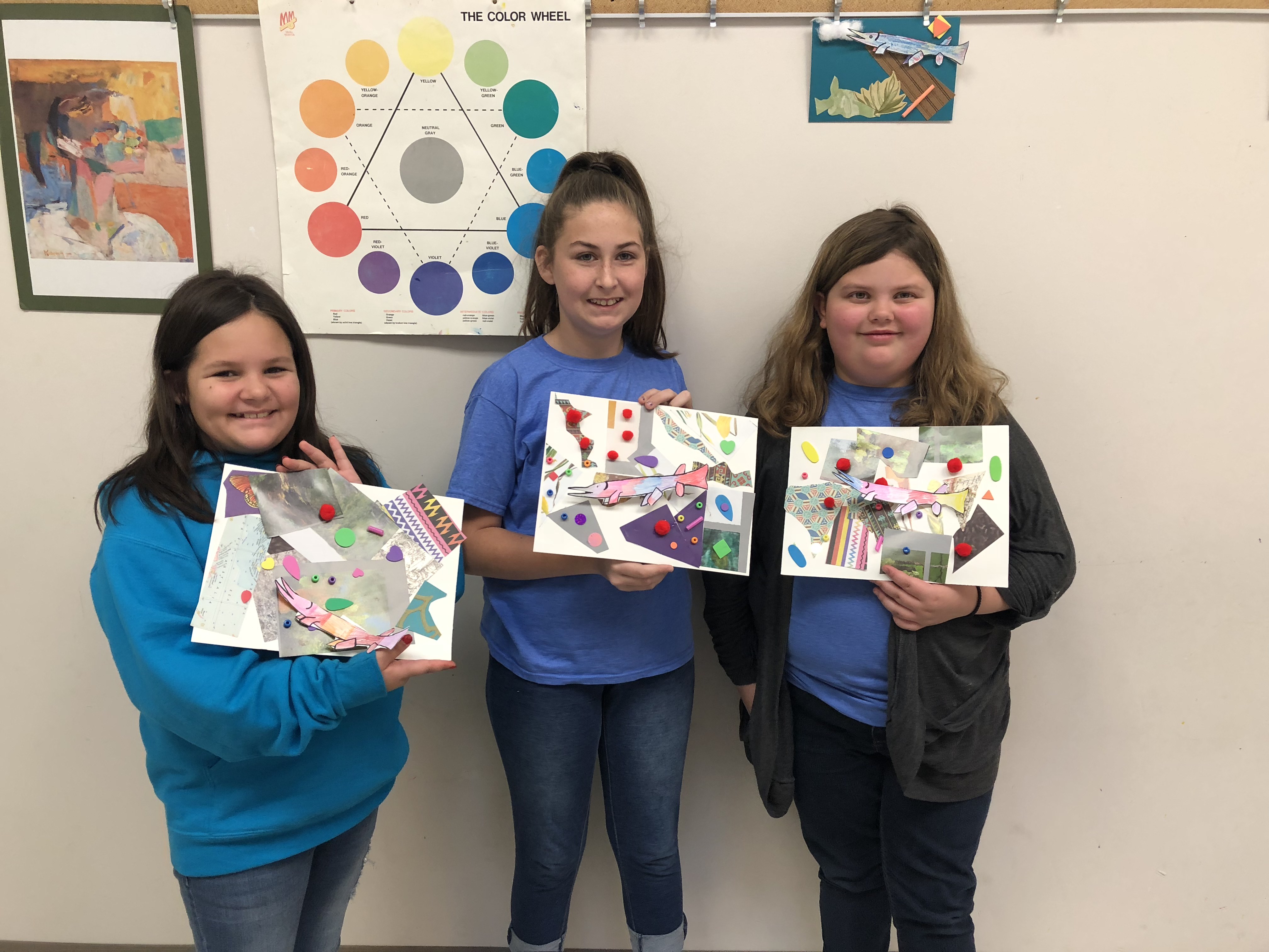 Students holding paintings Students holding paintings