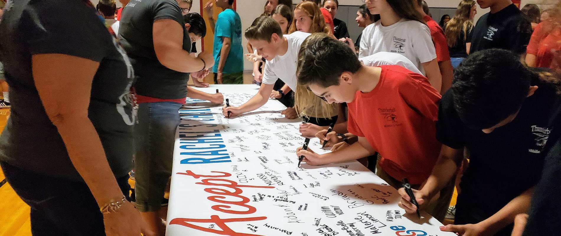 picture of students signing Rachel's Challenge banner