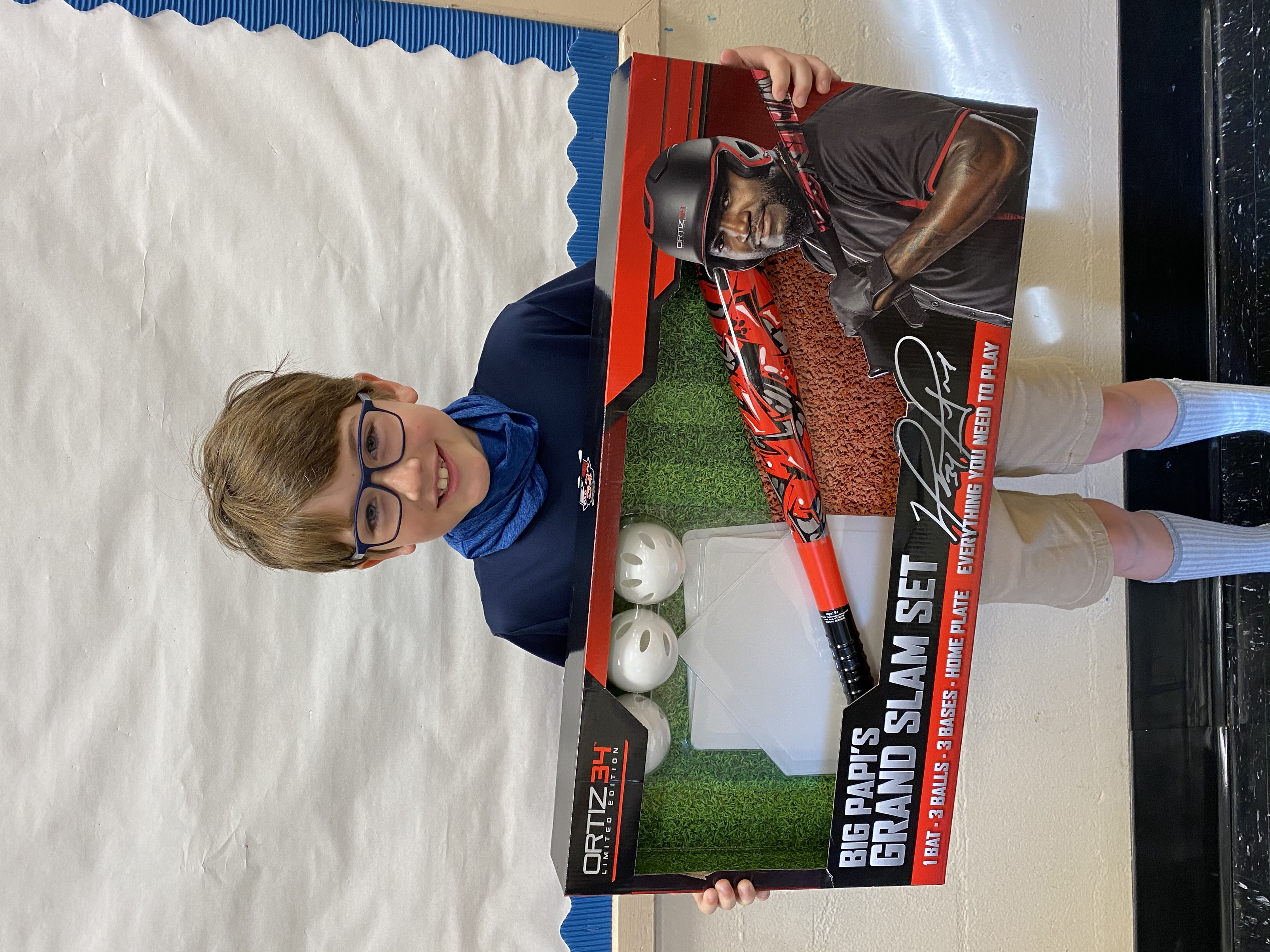 A student holding their Big Papi's Grand Slam Set they won.