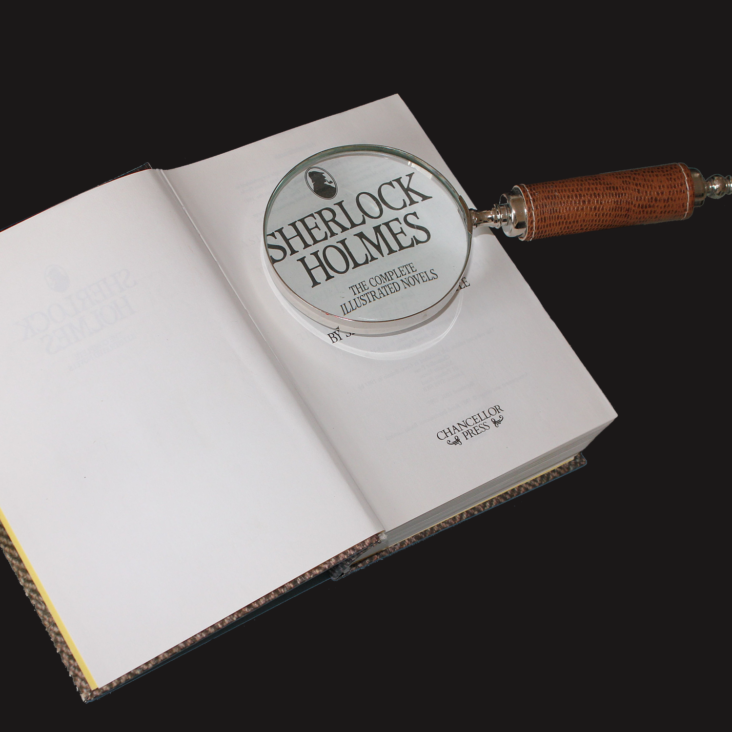 Sherlock Holmes book open with magnifying glass on it