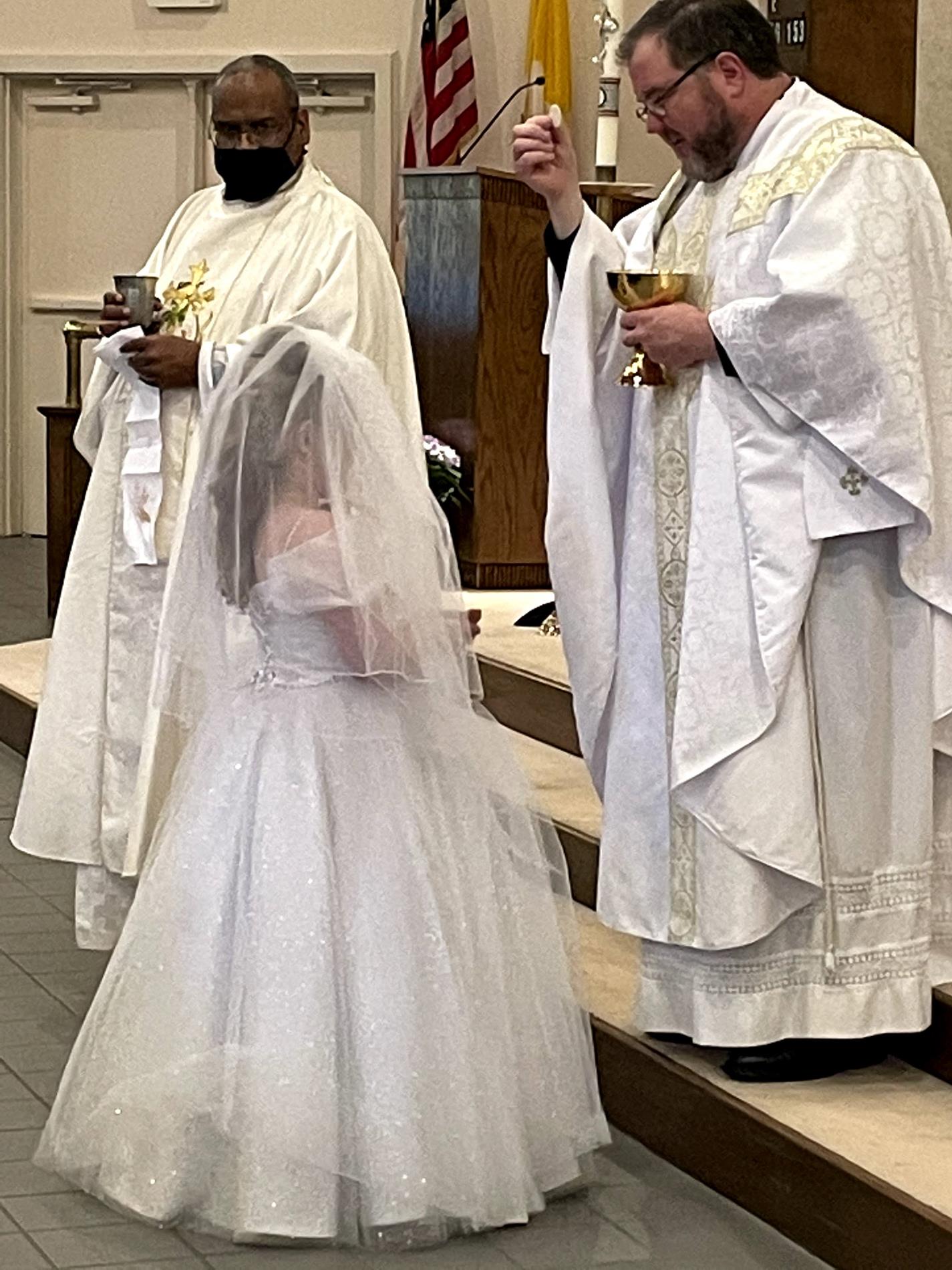 Jovie receives the Body of Christ