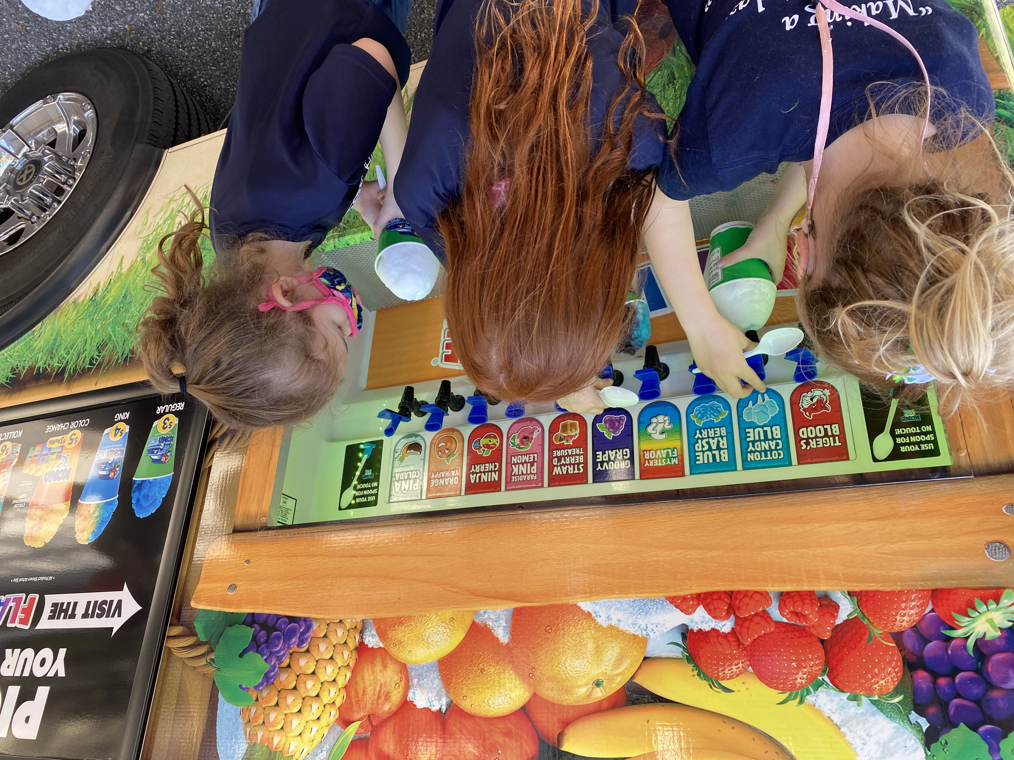 Students adding flavors to their Kona Ice