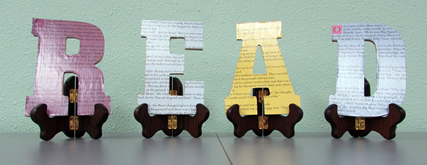 the word "Read" as separate letters on small easels made with book page coverings