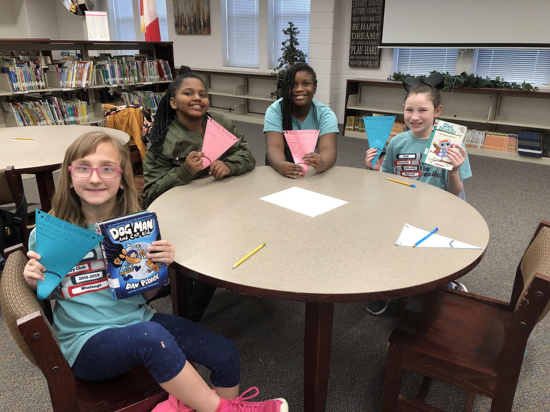 Students holding book reviews Students holding book reviews