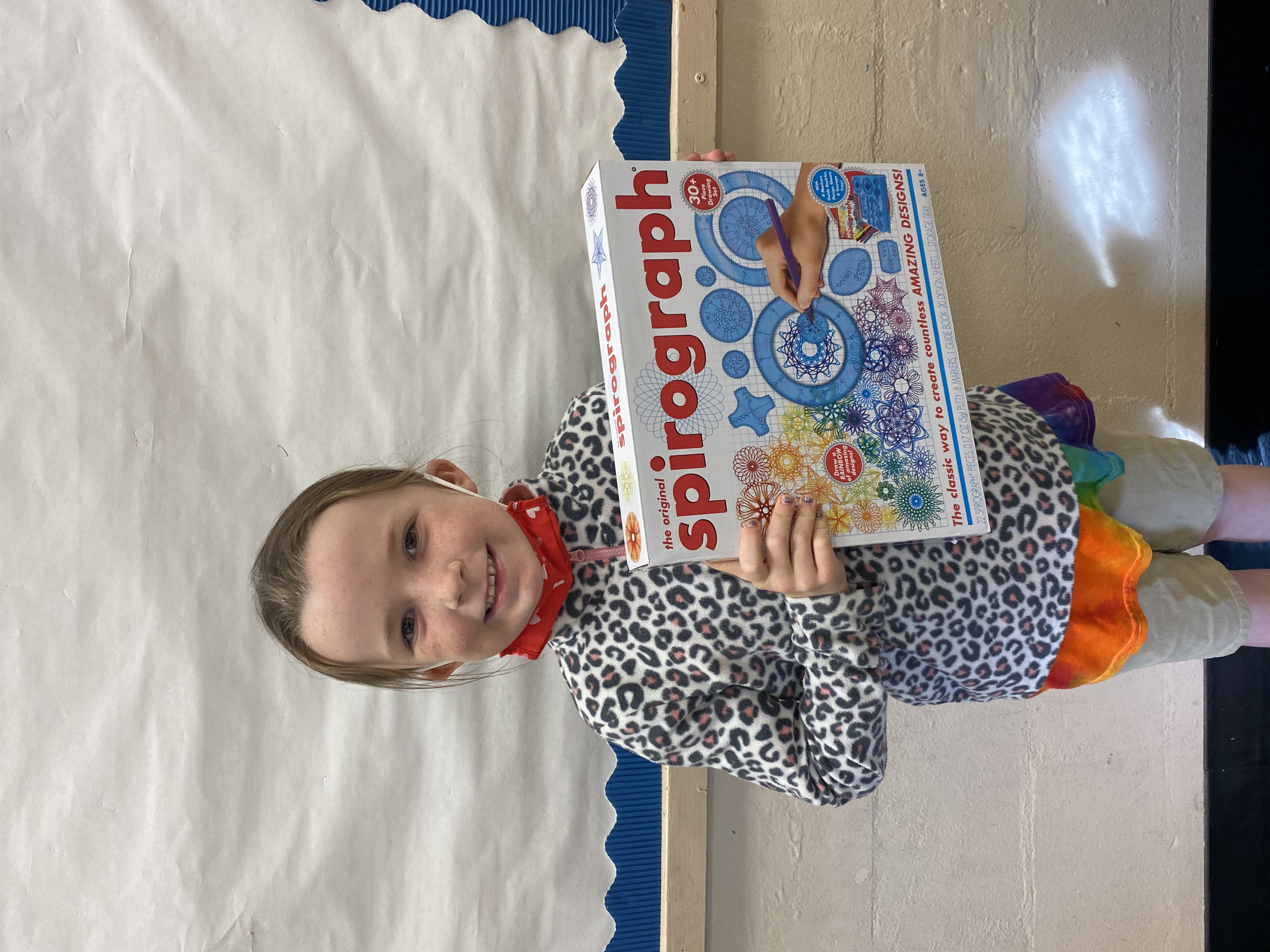 A student holding the Spirograph they won.