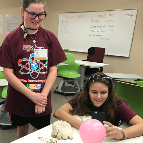 Girls work with balloon during STEM academy experiment