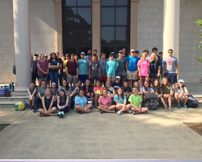 students gathered in front of building