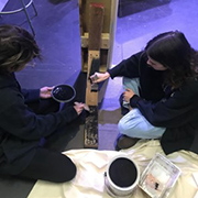 image of students working on setting up a stage