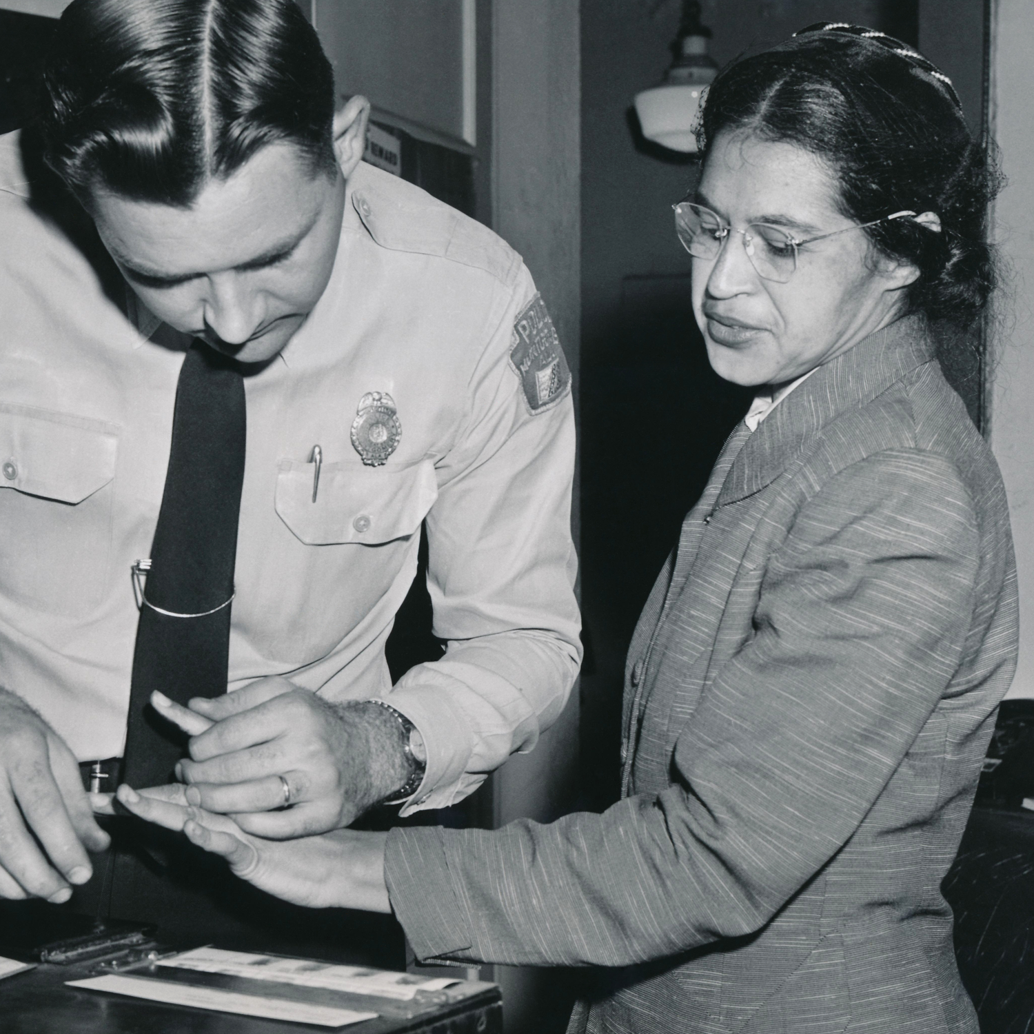 Rosa Parks being fingerprinted