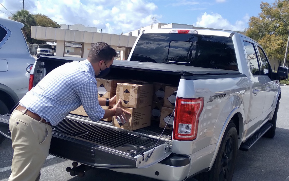 Mr. Fann loading the boxes for our school into his truck.