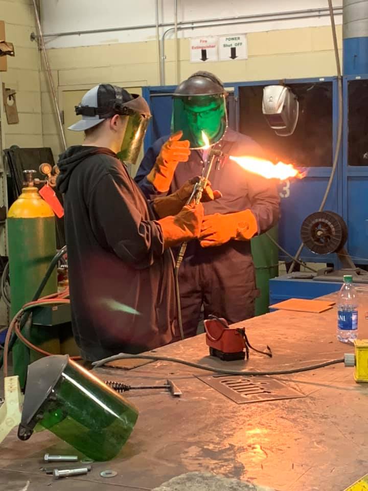 Student learning welding.