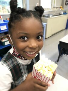 girl holding popcorn