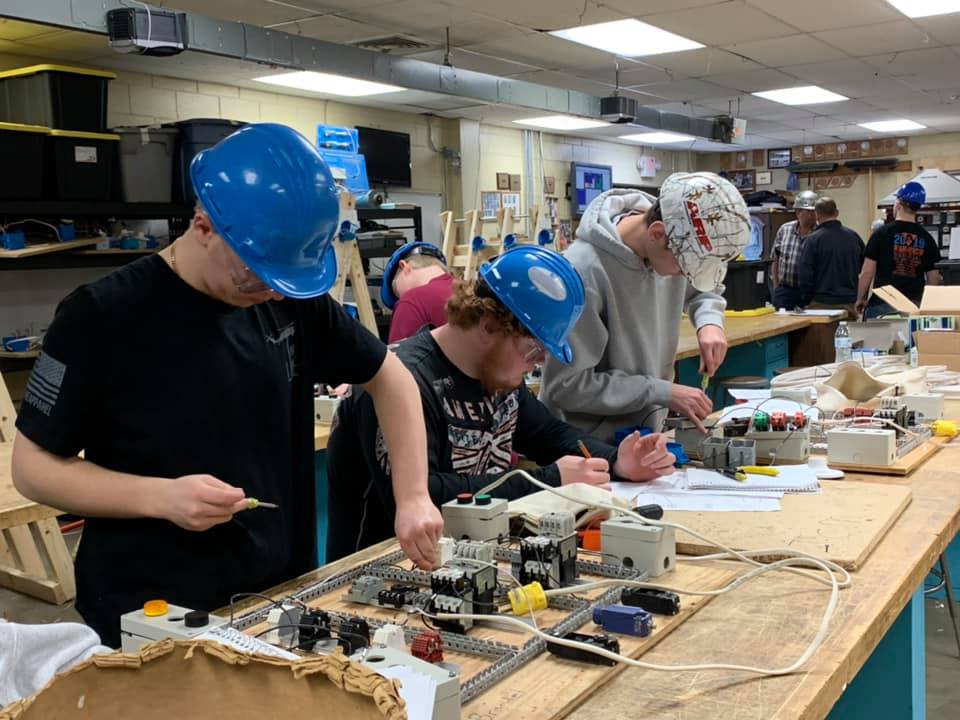 Electrical students learning skills to apply in future careers and in the house CBT students built.