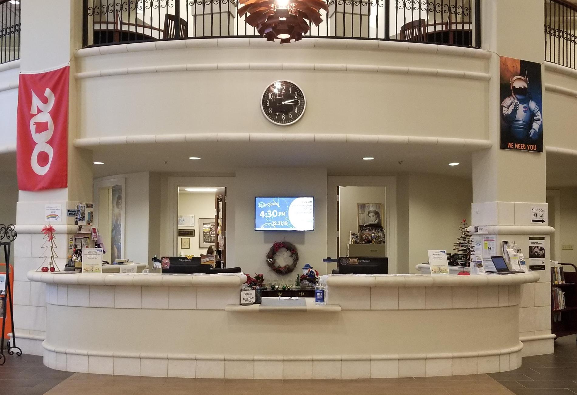 view of the SFPL front desk and mezzanine balcony from the entry doorway.