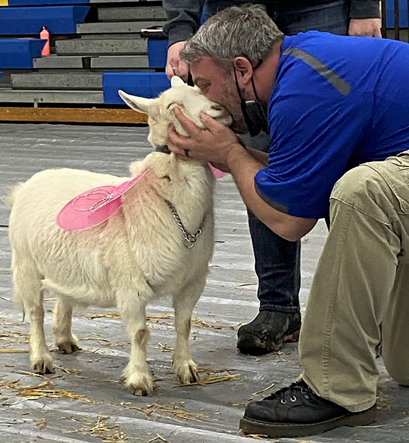 Mr. Krulik kiss-the-critter, the happy goat