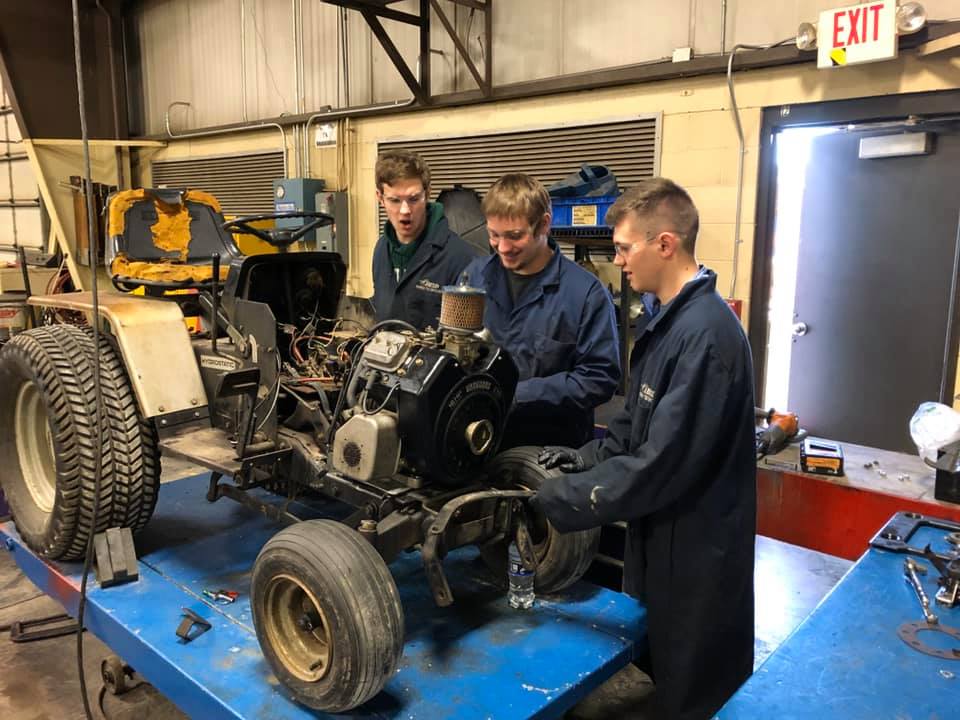 Students working on a small engine.