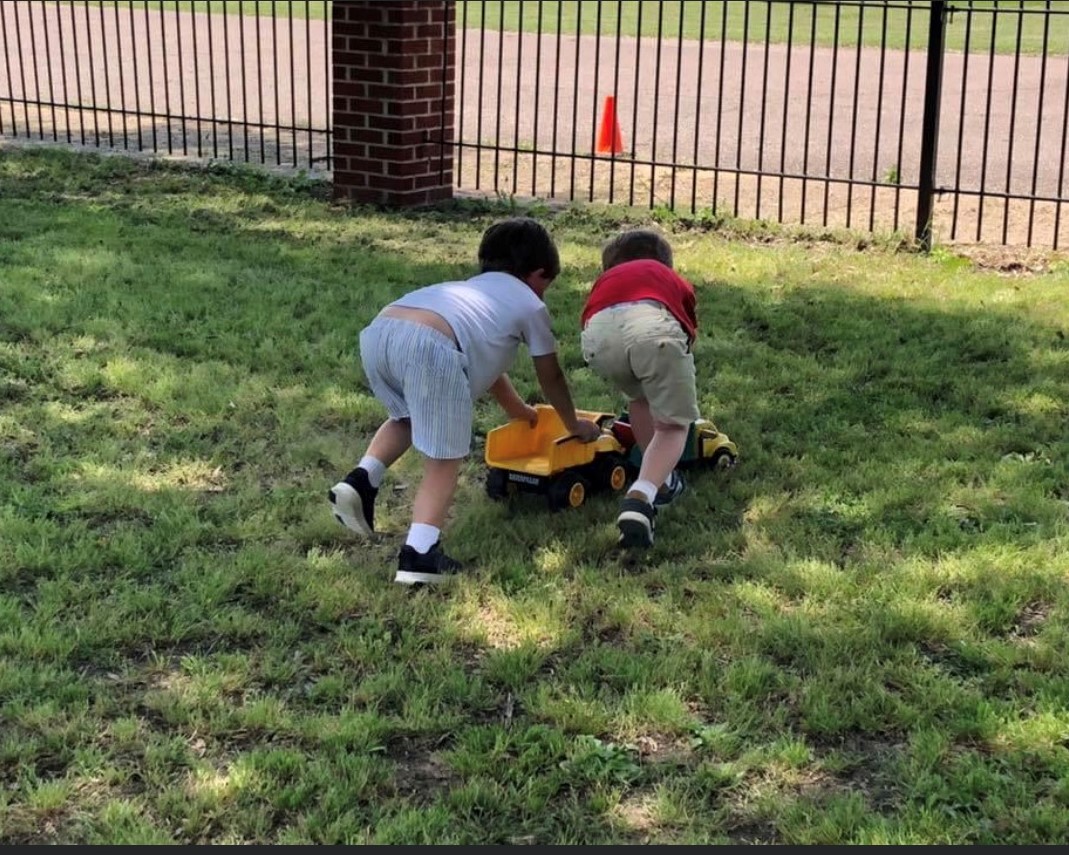 boys pushing truck