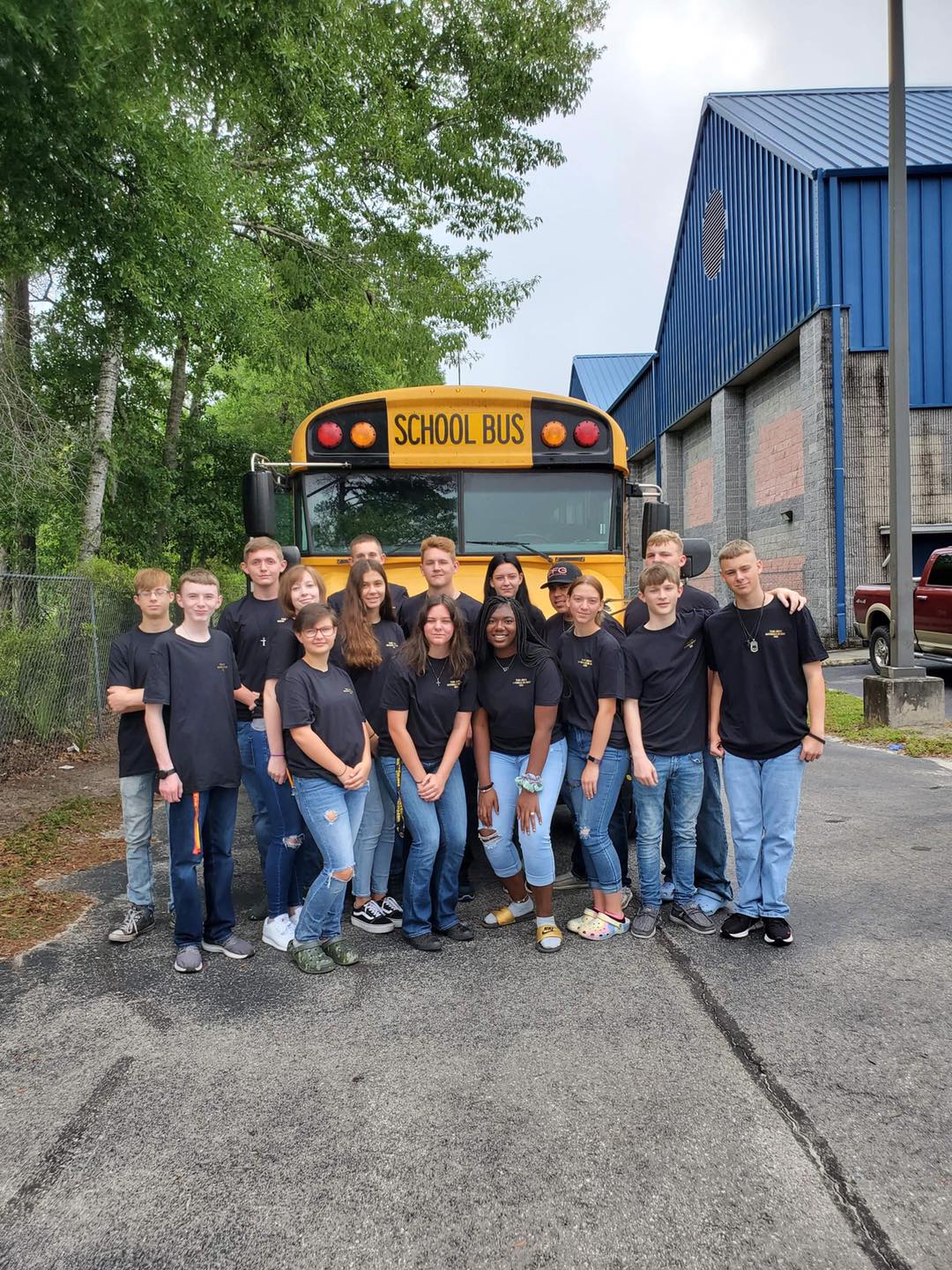 ROTC  in front of school bus