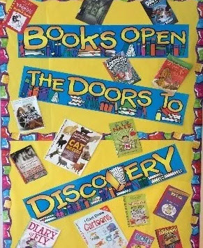 poster saying books open the doors to discovery on a wall