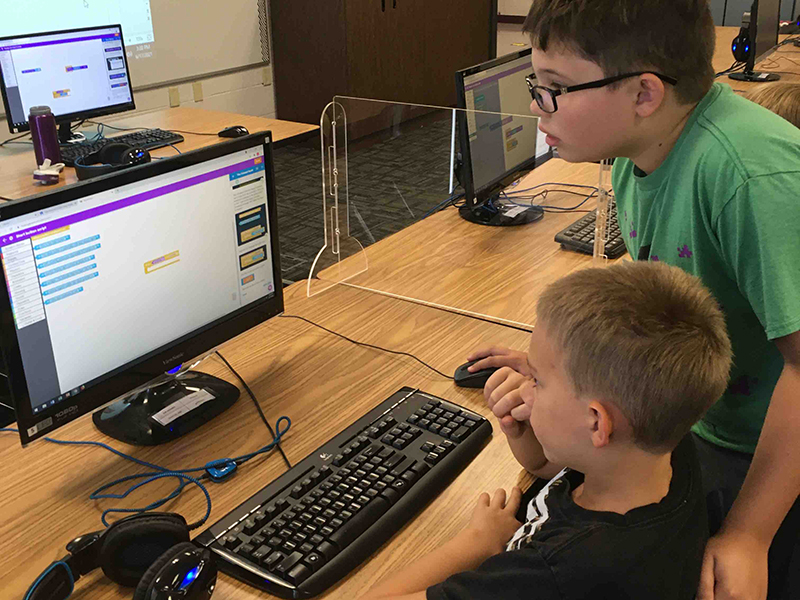 boys work on coding at STEM Academy
