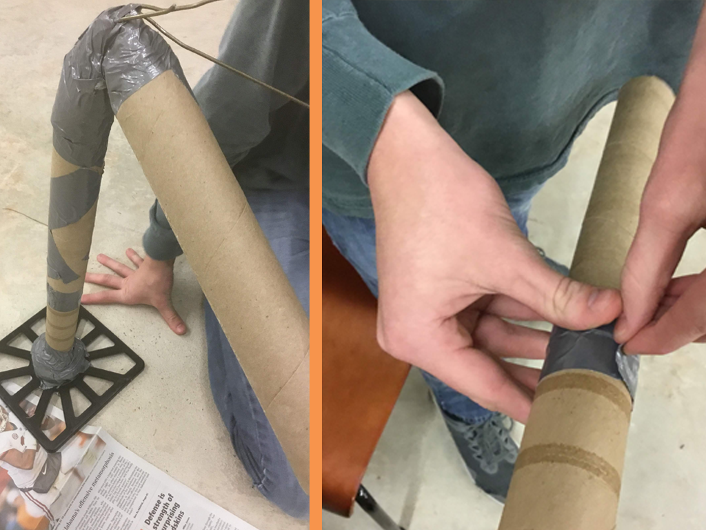 The legs of the lunar lander being built; paper towel tubes and duct tape