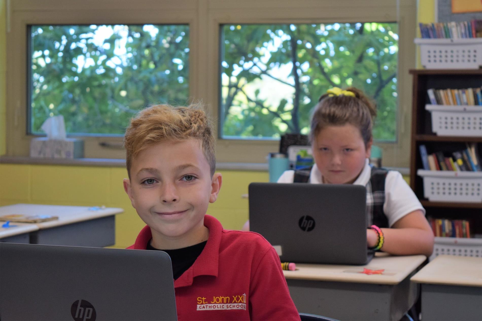 boy and girl at desk working on laptop boy and girl at desk working on laptop