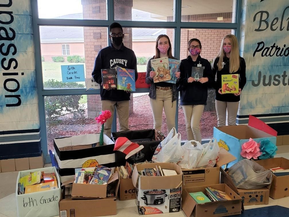 students with books collected for book drive