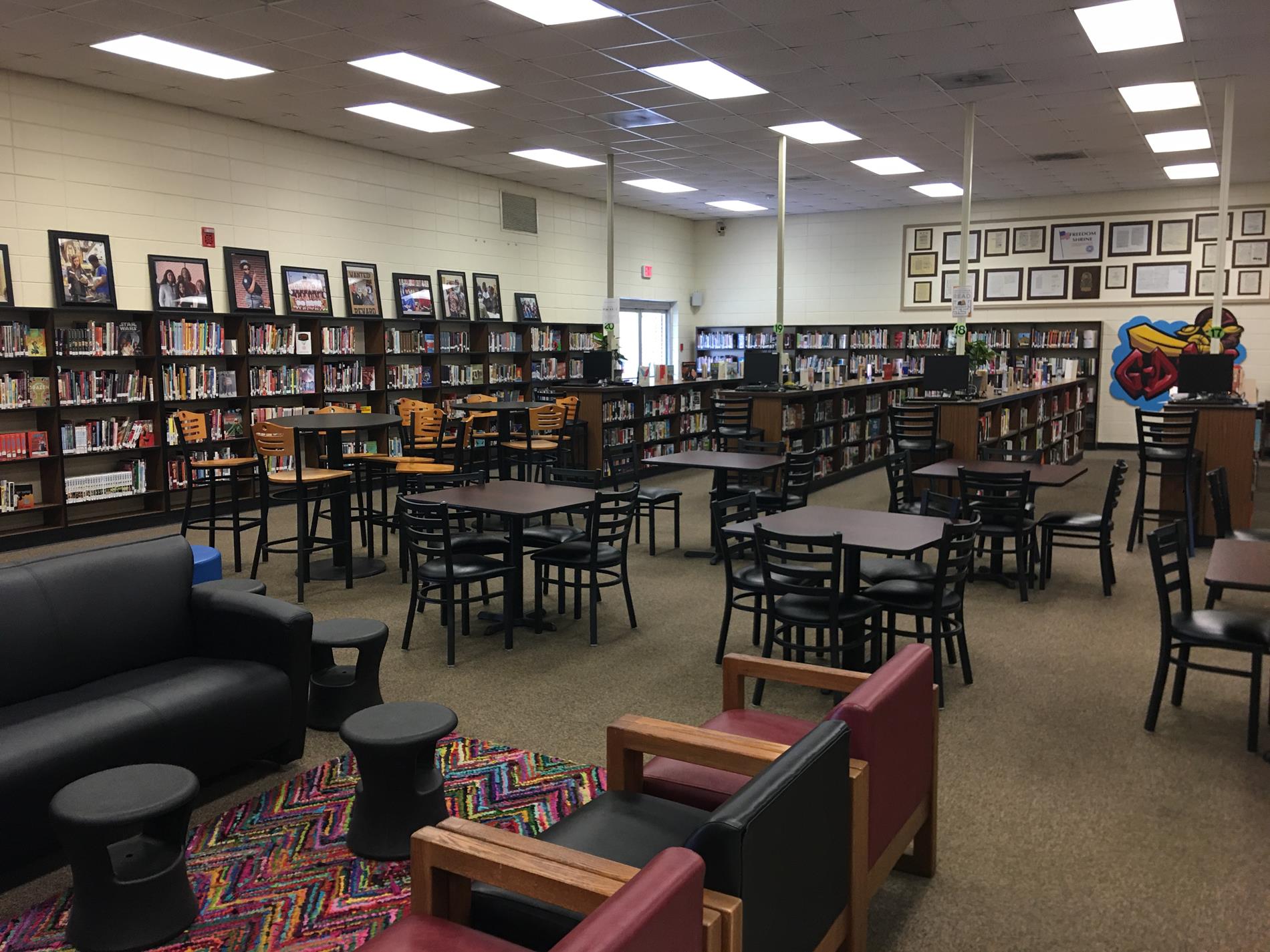 Photo of tables, chairs, and book shelves in the GWCFC media center