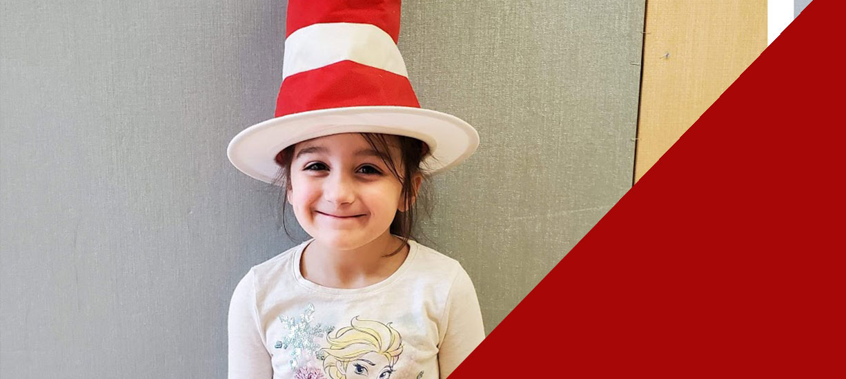 Student wearing Dr. Seuss Hat (school event) and smiling