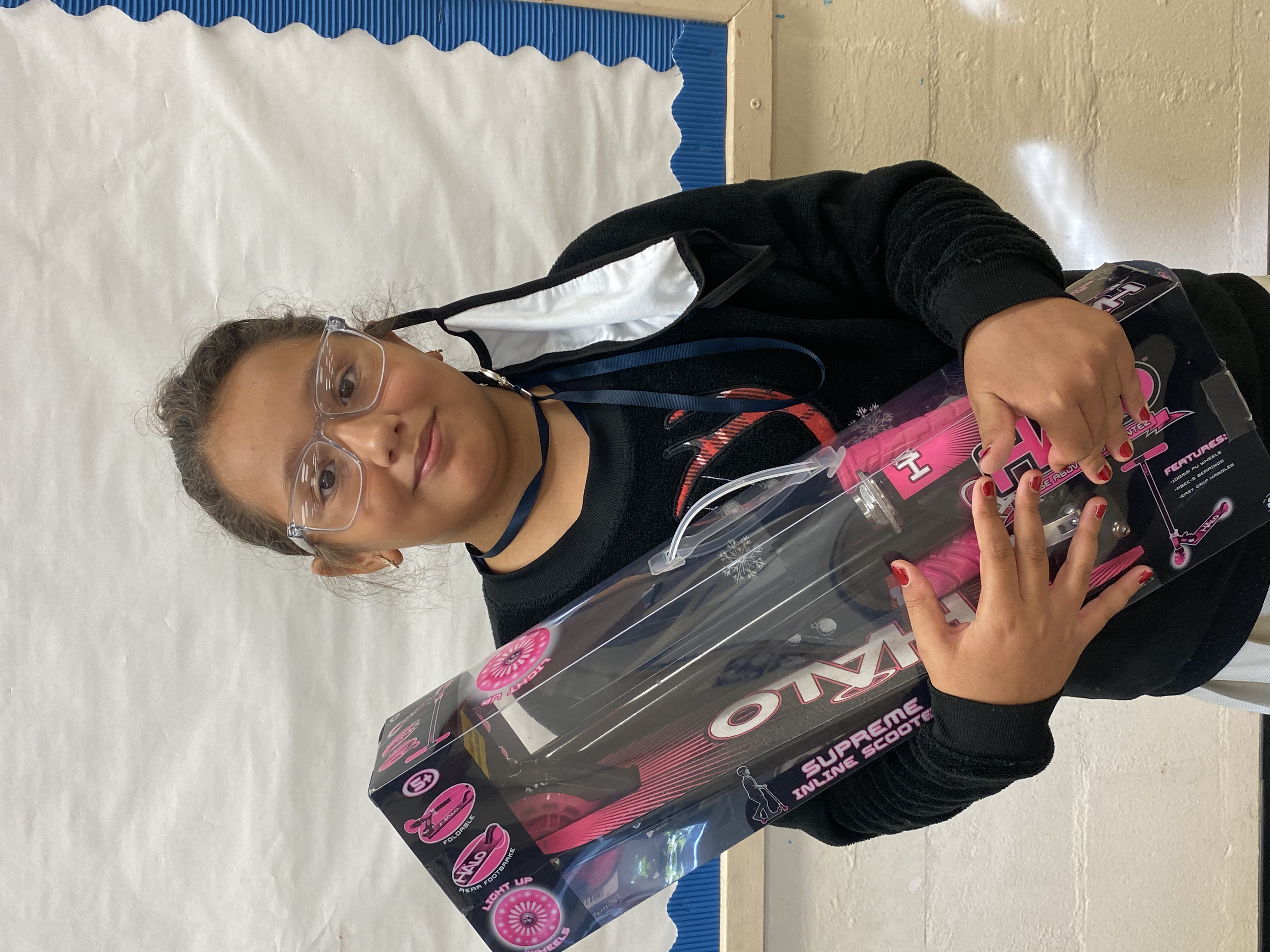 A student holding the Halo Scooter they won.