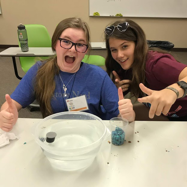 2 girls run experiment at STEM academy