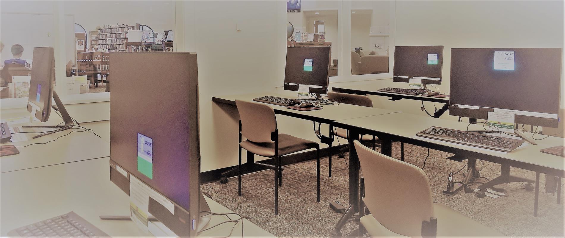 computers stations on tables in library