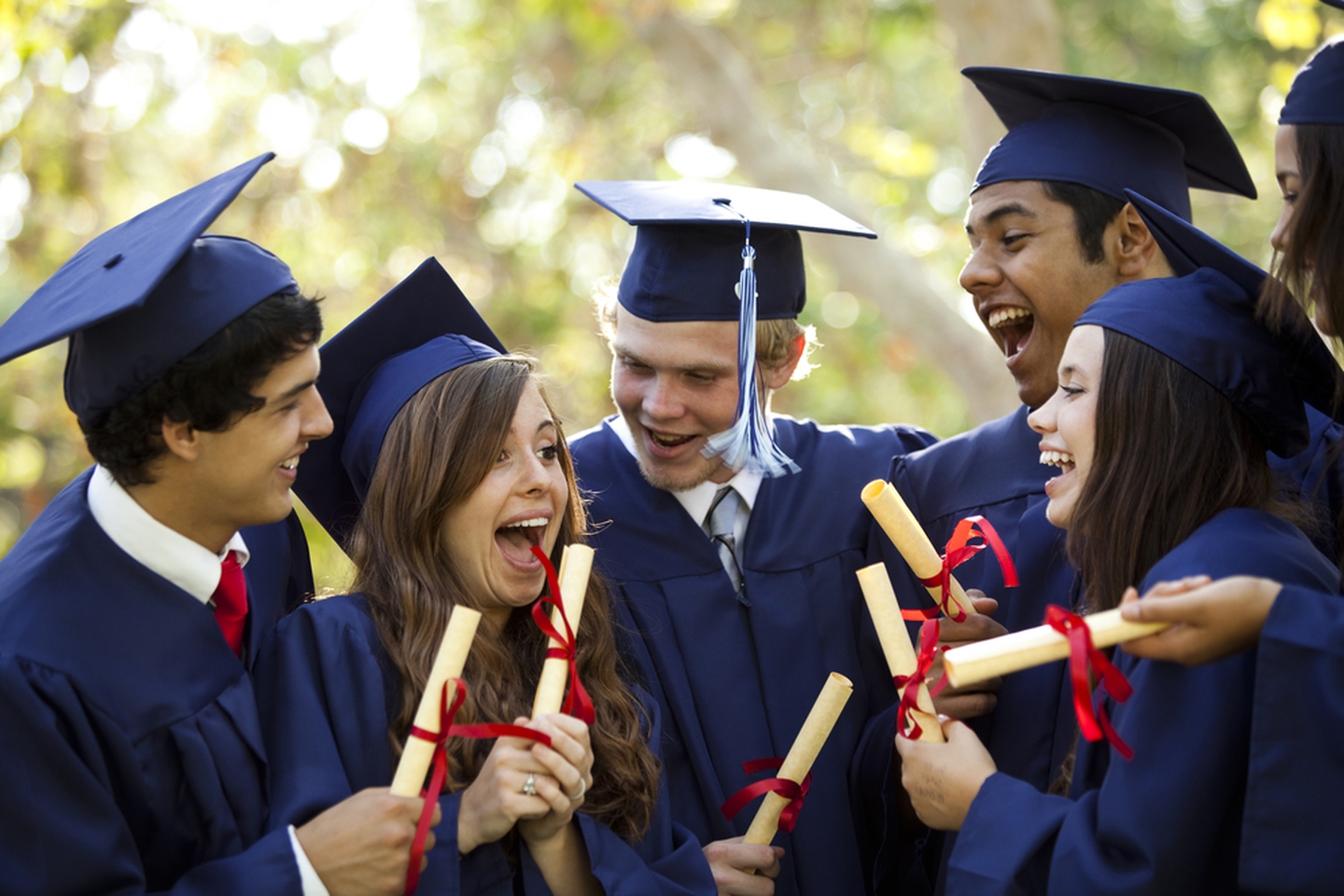 Graduates holding diplomas