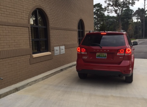 vehicle stopped at drive thru drop box located outside the library on the west side of the Spanish Fort Community Center building vehicle stopped at drive thru drop box located outside the library on the west side of the Spanish Fort Community Center building