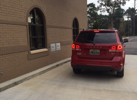 vehicle stopped at drive thru drop box located outside the library on the west side of the Spanish Fort Community Center building