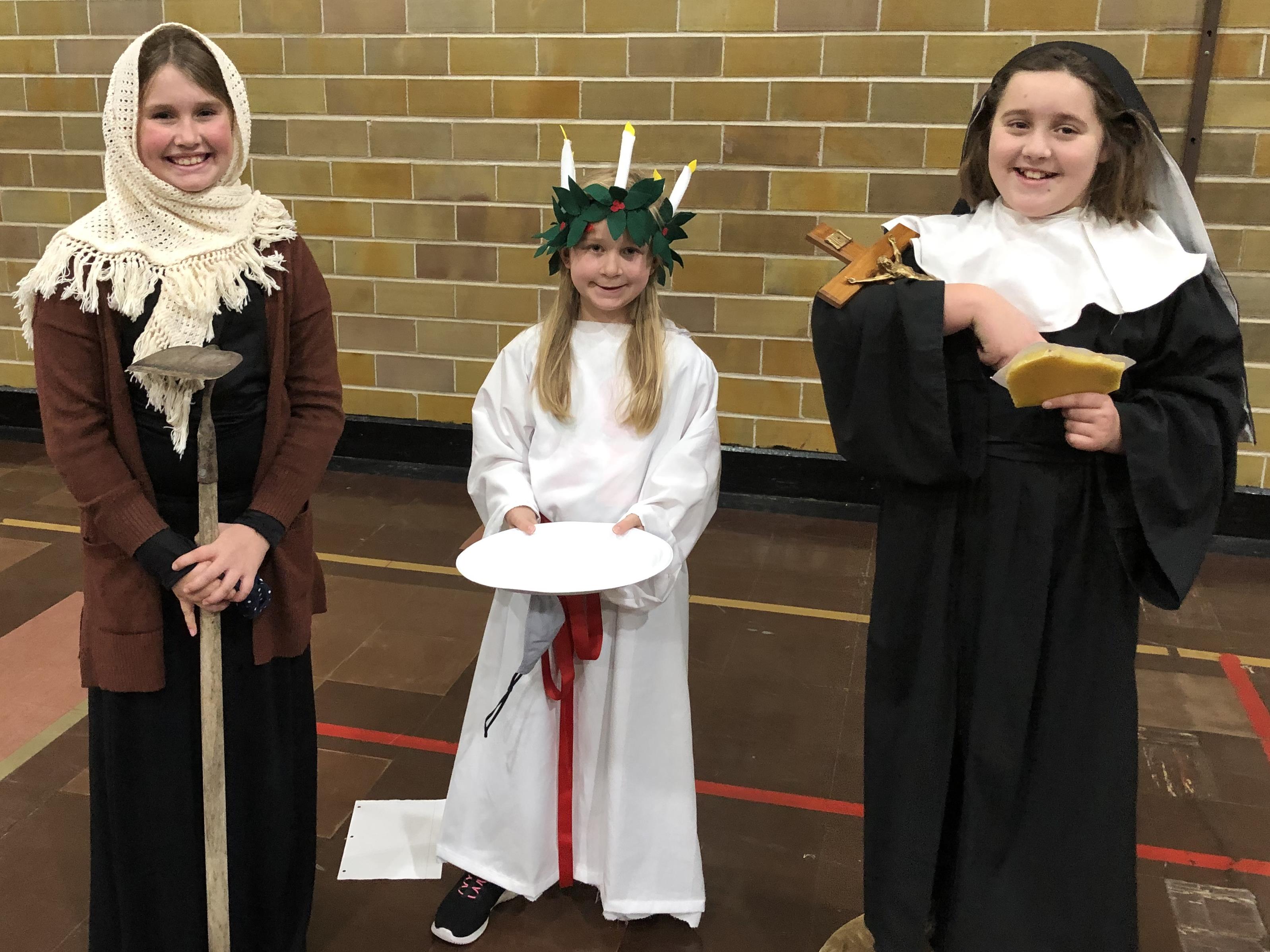 Three girls dressed as saints