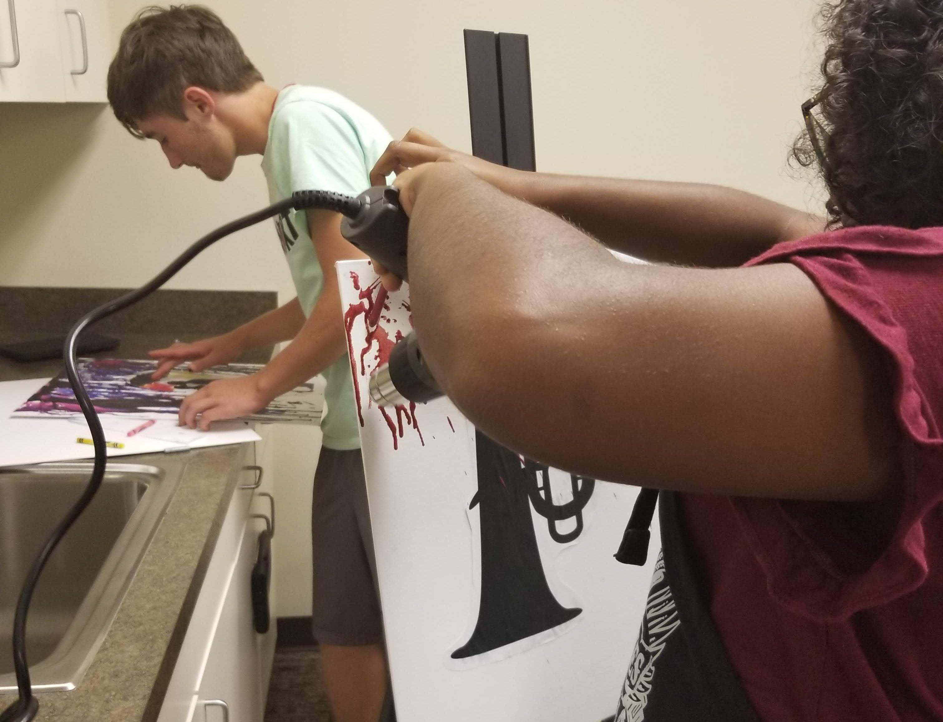 Teens working on melting crayon art project